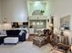 Bright living room with sectional sofa, ottoman, and wicker chairs, overlooking kitchen and dining area at 1481 Center Street Ext # 1808, Mount Pleasant, SC 29464