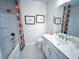 Bathroom with white vanity, toilet and colorful shower curtain at 1573 Trailmore Ln, Summerville, SC 29486