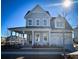 Two-story house with gray siding, a front porch, and a two-car garage at 1573 Trailmore Ln, Summerville, SC 29486