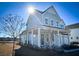 Two-story house with gray siding, a front porch, and a two-car garage at 1573 Trailmore Ln, Summerville, SC 29486