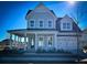 Two-story house with gray siding, a front porch, and a two-car garage at 1573 Trailmore Ln, Summerville, SC 29486