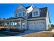 Two-story house with gray siding, a front porch, and a two-car garage at 1573 Trailmore Ln, Summerville, SC 29486