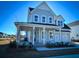 Two-story farmhouse with gray siding, metal roof, and front porch at 1573 Trailmore Ln, Summerville, SC 29486