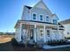 Two-story farmhouse with gray siding, metal roof, and front porch at 1573 Trailmore Ln, Summerville, SC 29486
