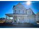Two-story house with gray siding, a front porch, and a two-car garage at 1573 Trailmore Ln, Summerville, SC 29486