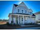 Two-story farmhouse with gray siding, metal roof, and front porch at 1573 Trailmore Ln, Summerville, SC 29486