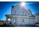 Two-story farmhouse with gray siding, metal roof, and front porch at 1573 Trailmore Ln, Summerville, SC 29486