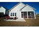 Home's exterior features gray siding and a screened porch with patio at 1573 Trailmore Ln, Summerville, SC 29486