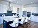Modern kitchen with white cabinets, a large island, and stainless steel appliances at 1573 Trailmore Ln, Summerville, SC 29486