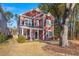 Two-story red house with a large tree in the front yard at 1687 Seabago Dr, Charleston, SC 29414