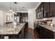 Well-equipped kitchen with granite countertops, dark cabinetry, and stainless steel appliances at 1687 Seabago Dr, Charleston, SC 29414