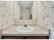Small bathroom with bird wallpaper and pedestal sink at 1723 Live Oak Park # 1723, Seabrook Island, SC 29455