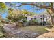 Back of house with screened porch and lush landscaping at 1723 Live Oak Park # 1723, Seabrook Island, SC 29455