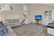 Open living area with hardwood floors, TV, and built-in shelving at 1723 Live Oak Park # 1723, Seabrook Island, SC 29455