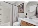 Clean bathroom with shower/tub combo, wood vanity, and round mirror at 1815 Dogwood Rd # 804, Charleston, SC 29414