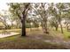 Landscaped backyard with mature trees and a walkway at 1860 Headquarters Plantation Dr, Johns Island, SC 29455