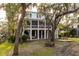 House with large backyard, mature trees, and wooden deck at 1860 Headquarters Plantation Dr, Johns Island, SC 29455
