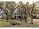 Spacious backyard with wooden footbridge, lush landscaping, and mature oak trees at 1860 Headquarters Plantation Dr, Johns Island, SC 29455