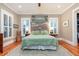 Serene bedroom features a rustic wood headboard, light green bedding, and hardwood floors at 1860 Headquarters Plantation Dr, Johns Island, SC 29455