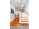 Bright entry with hardwood floors, white wainscoting, and staircase leading to the upper level at 1860 Headquarters Plantation Dr, Johns Island, SC 29455
