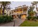 Two story home with a large porch and two car garage at 1860 Headquarters Plantation Dr, Johns Island, SC 29455