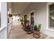 Front porch with rocking chairs, plants, and hanging baskets at 1860 Headquarters Plantation Dr, Johns Island, SC 29455