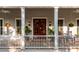 Spacious front porch with rocking chairs and hanging flower baskets at 1860 Headquarters Plantation Dr, Johns Island, SC 29455