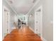 Long hallway with hardwood floors and access to multiple rooms at 1860 Headquarters Plantation Dr, Johns Island, SC 29455