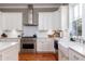 Kitchen boasts white cabinets, farmhouse sink, and stainless steel appliances at 1860 Headquarters Plantation Dr, Johns Island, SC 29455