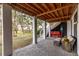 Covered patio with comfortable seating and exterior lighting at 1860 Headquarters Plantation Dr, Johns Island, SC 29455