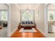 Bright sitting room with hardwood floors and a comfy couch at 1860 Headquarters Plantation Dr, Johns Island, SC 29455