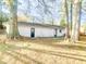 House exterior showcasing a large backyard with mature trees at 200 Elliott Dr, Ladson, SC 29456