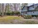 Backyard view of house, grassy area, and trees at 220 Runnymede Ln, Summerville, SC 29485