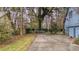 House driveway, grassy area, and trees at 220 Runnymede Ln, Summerville, SC 29485