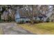 House front view, driveway, and landscaping at 220 Runnymede Ln, Summerville, SC 29485