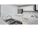 Kitchen boasts an island, stainless steel sink, and white cabinets at 230 Eagle Ridge Rd, Summerville, SC 29485
