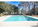 Inviting community swimming pool surrounded by trees at 2323 Tall Sail Dr # F, Charleston, SC 29414