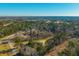 Wide aerial view showing the manufactured home's location in a quiet neighborhood at 240 Carolina Dr, Saint Stephen, SC 29479