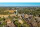 An aerial view showcases the property amongst a canopy of trees with a view of a nearby water tower at 240 Carolina Dr, Saint Stephen, SC 29479
