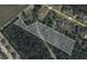 This aerial view shows the property's boundary lines, the surrounding vegetation and street access at 240 Carolina Dr, Saint Stephen, SC 29479