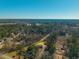 Aerial view of a manufactured home nestled in a wooded neighborhood at 240 Carolina Dr, Saint Stephen, SC 29479