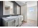 Modern bathroom with dual sinks, a large mirror, and walk-in closet at 240 Carolina Dr, Saint Stephen, SC 29479