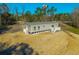 Rear view of a manufactured home showcasing its deck and woodland setting at 240 Carolina Dr, Saint Stephen, SC 29479