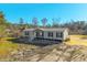 Single-wide manufactured home with neutral siding, white trim, and a deck at 240 Carolina Dr, Saint Stephen, SC 29479