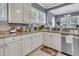 L-shaped kitchen with white cabinets, granite counters, and stainless steel appliances at 253 Fox Field Rd, Walterboro, SC 29488