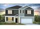 Two-story home with gray and beige siding, a two-car garage, and landscaping at 289 Blue Haw Dr, Moncks Corner, SC 29461