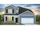 Two-story house with gray siding, black shutters, and a white garage door at 291 Blue Haw Dr, Moncks Corner, SC 29461