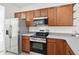 Stainless steel appliances and wood cabinets in the kitchen at 3026 Gulfstream Ln, Ridgeville, SC 29472