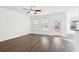 Living room with hardwood floors, windows, and back door access at 3026 Gulfstream Ln, Ridgeville, SC 29472