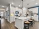 Modern kitchen with white cabinets, island, and stainless steel appliances at 3206 Safe Harbor Way, Charleston, SC 29414